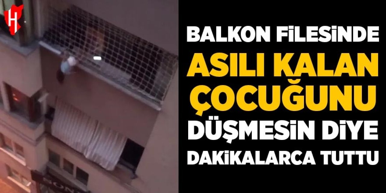 Balkon filesinde asılı kalan çocuğunu düşmesin diye dakikalarca tuttu